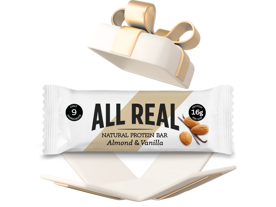 All Real protein bar packaging with a gold ribbon on a white background
