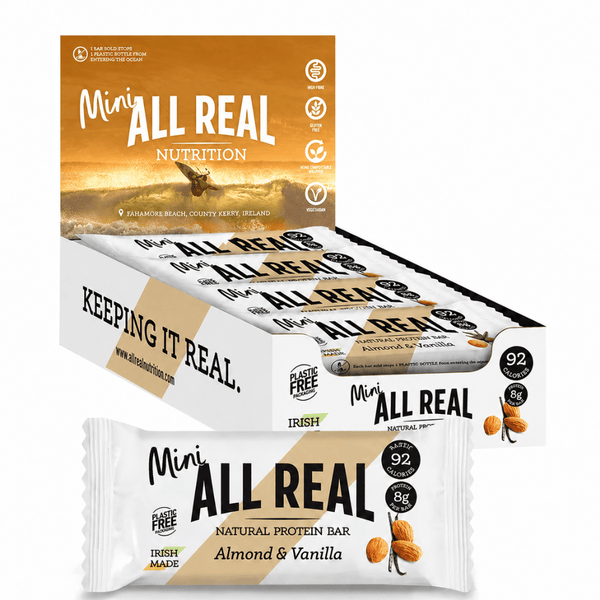 Box of Mini Almond and Vanilla All Real Nutrition protein bars with a focus on one bar.