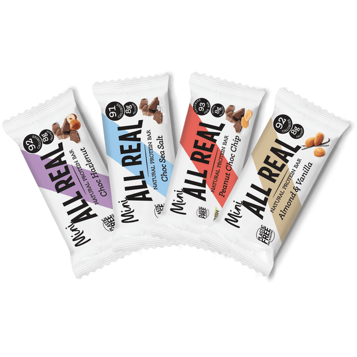 Four packages of All Real mini protein bars on a white background