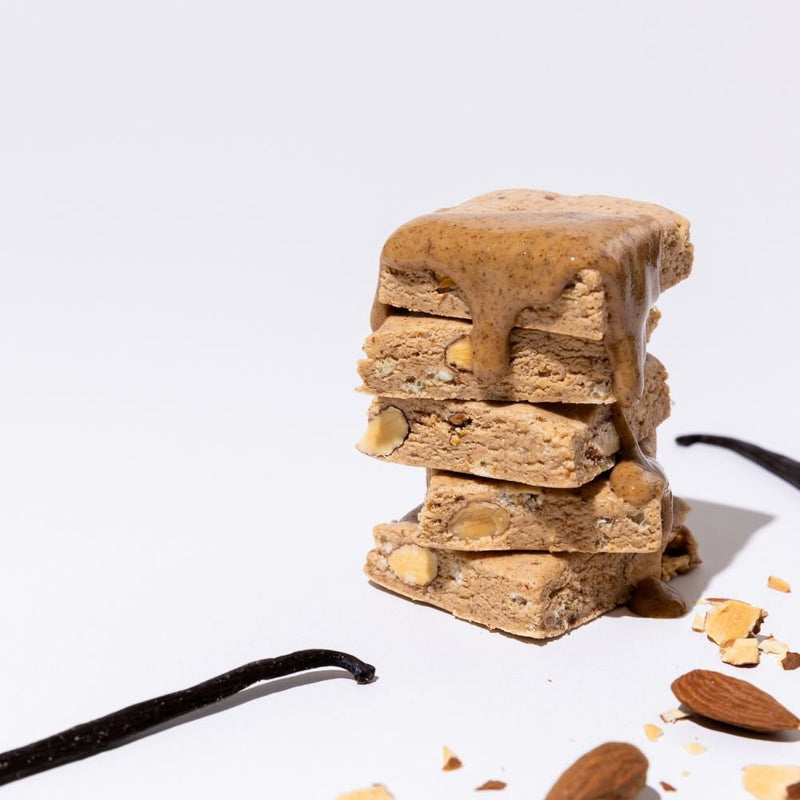All Real almond vanilla protein bar stack with almonds and vanilla