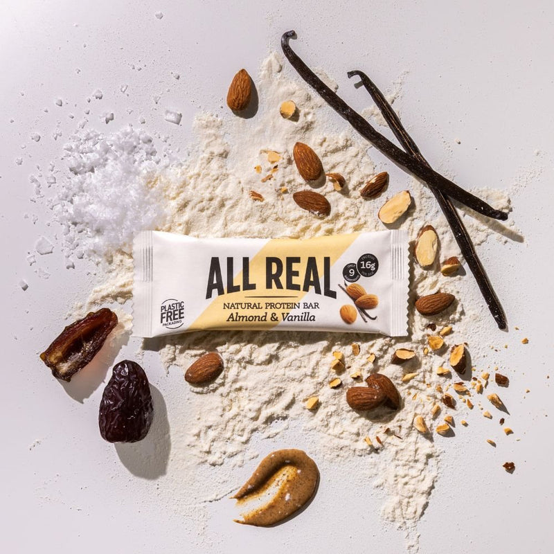 All Real almond vanilla protein bar with almonds and vanilla pods on ingredient background
