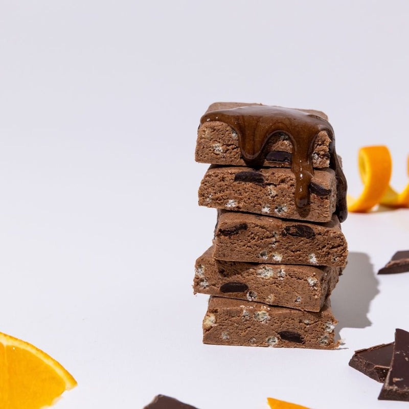 All Real chocolate orange protein bar stack with orange slices
