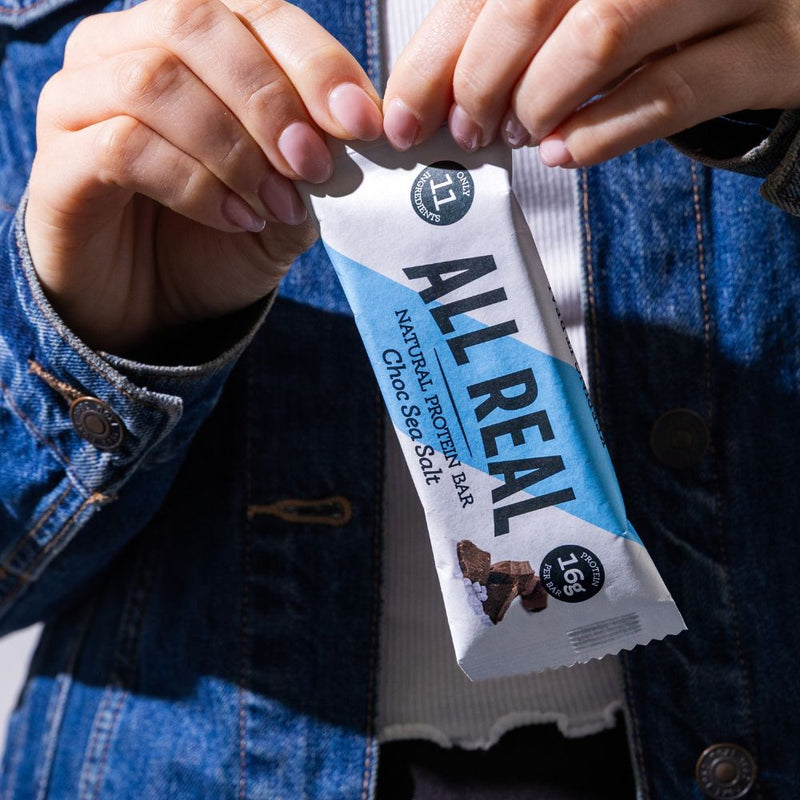 Opening an All Real chocolate sea salt protein bar