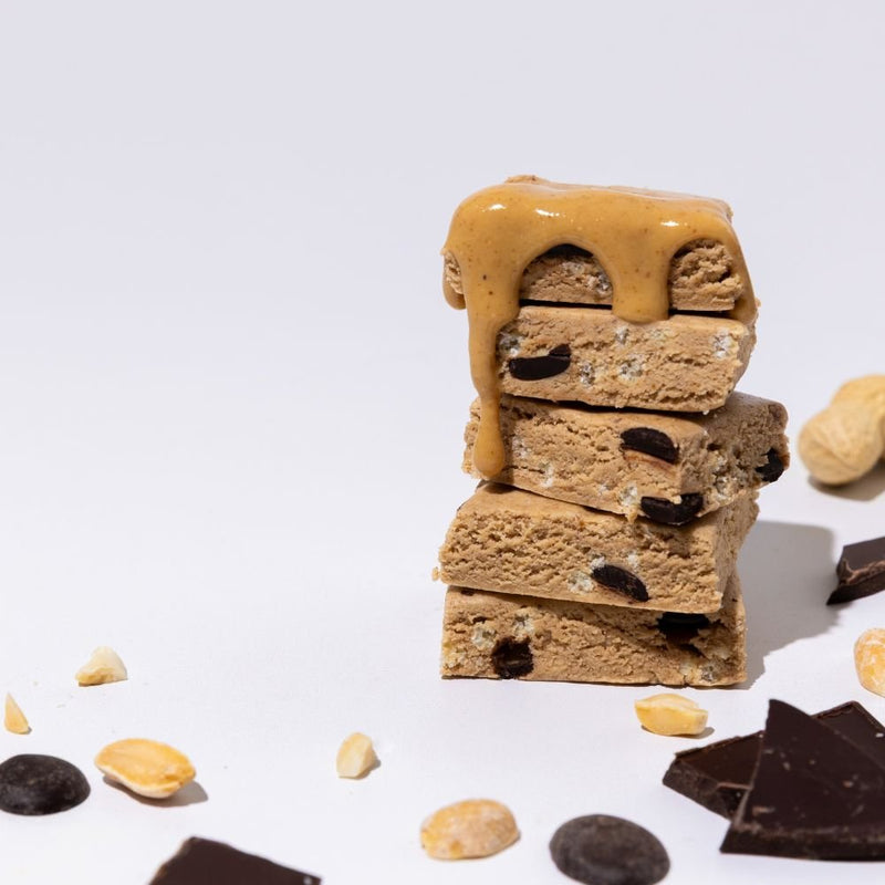 All Real peanut chocolate chip protein bar stack with chocolate chips